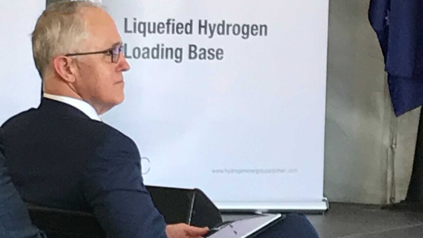 Prime Minister Malcolm Turnbull pictured in front of sign that reads 'Port of Hastings Liquefied Hydrogen Loading Base'