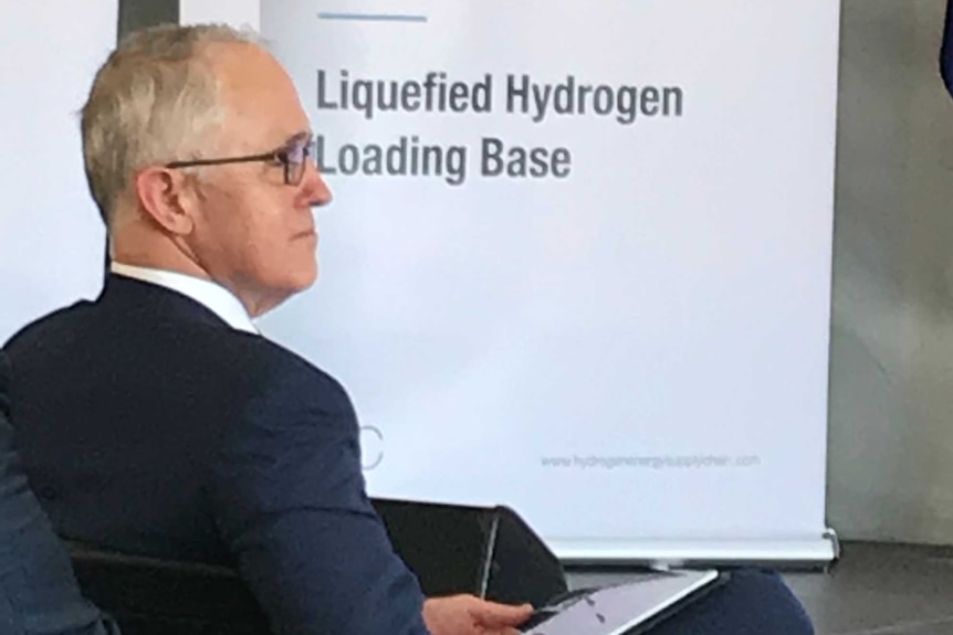 Prime Minister Malcolm Turnbull pictured in front of sign that reads 'Port of Hastings Liquefied Hydrogen Loading Base'