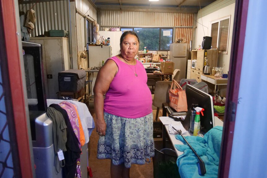 a woman in a tin shed that's been fitted out to become a home
