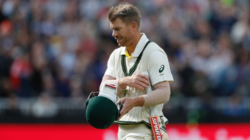David Warner looks to the ground as he walks off following a dismissal