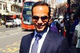 Paul Manafort's former aide George Papadopoulos holding a briefcase.