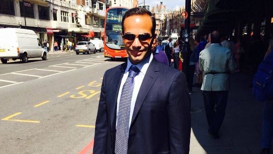 Paul Manafort's former aide George Papadopoulos holding a briefcase.