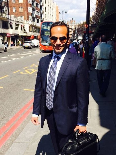 Paul Manafort's former aide George Papadopoulos holding a briefcase.