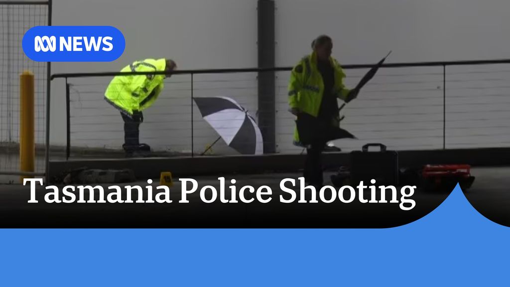 Tasmania Police Shooting: Police officers in high-vis raincoats and umbrellas.
