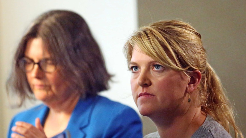 Alex Wubbels, right, looks on during an interview while her attorney Karra Porter.