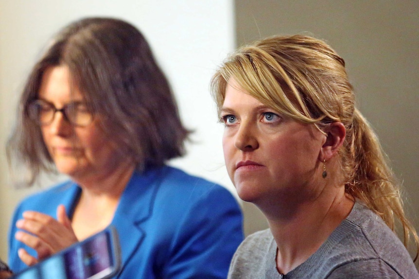 Alex Wubbels, right, looks on during an interview while her attorney Karra Porter.