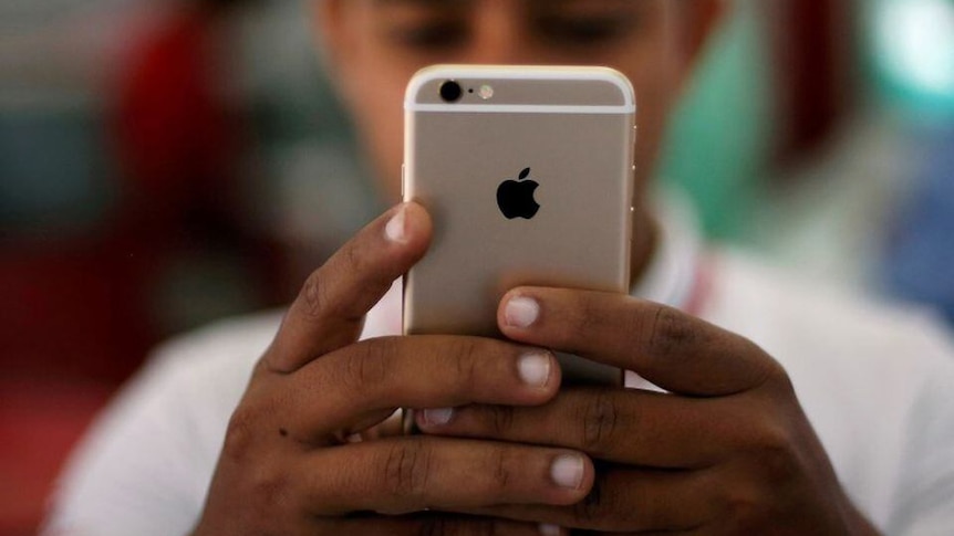 A man holding a smartphone with both hands 