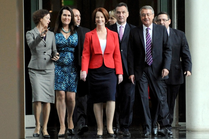 Julia Gillard arrives with supporters for the leadership vote at Parliament House in Canberra on February 27 (AAP: Alan Porritt)