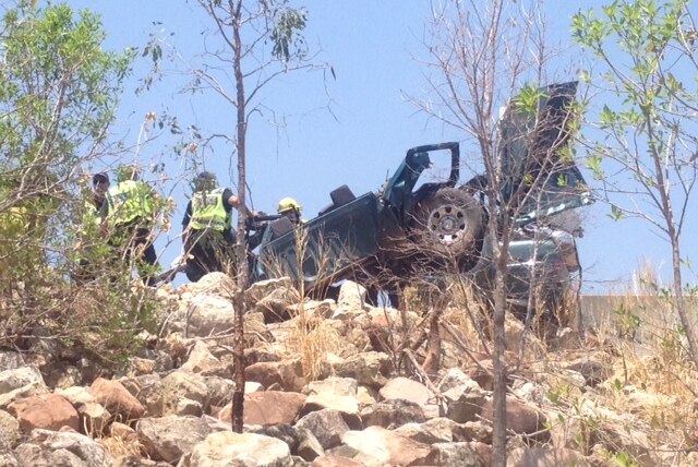 The wreckage of the 4WD is recovered from under the freight train in Katherine.