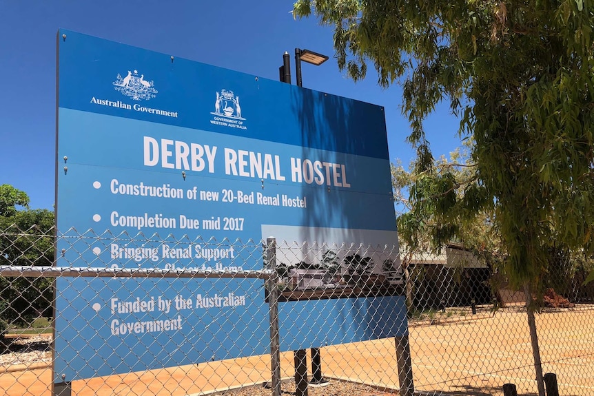 A photo of the sign outside Derby Renal Hostel saying completion is due mid 2017