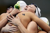 The Australian women's 4 x 100m relay team celebrate as one after breaking the Olympic record.