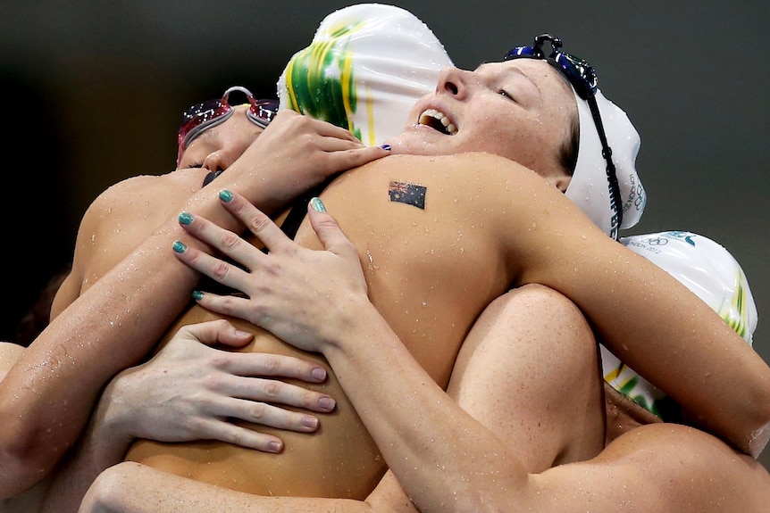 The Australian women's 4 x 100m relay team celebrate as one after breaking the Olympic record.