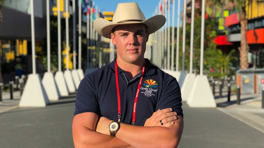 A staff member greets visitors to the Commonwealth Games Athlete's Village.