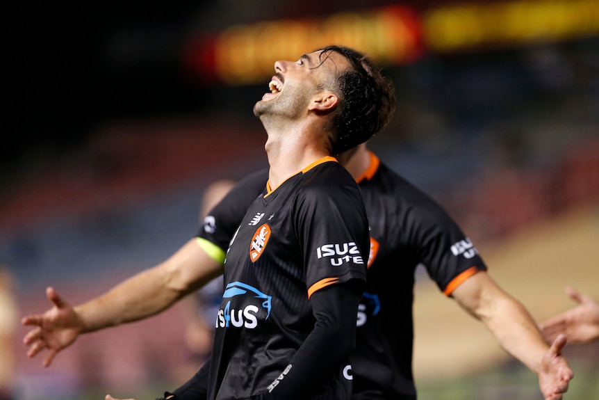 A Brisbane Roar A-League Men player celebrates scoring a goal.