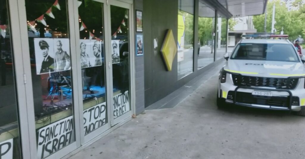 Bar declared crime scene as ACT police seize 'clearly satirical' posters under new hate laws