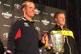 Don Pyke and Damien Hardwick smile while holding up the premiership cool.