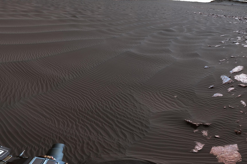 A rippled linear dune of dark Martian sand taken from the Mars rover