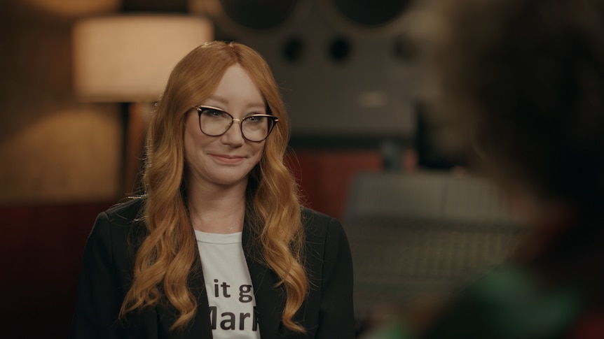 Tori Amos wearing glases with long hair looking at Zan Rowe who has her back to the camera