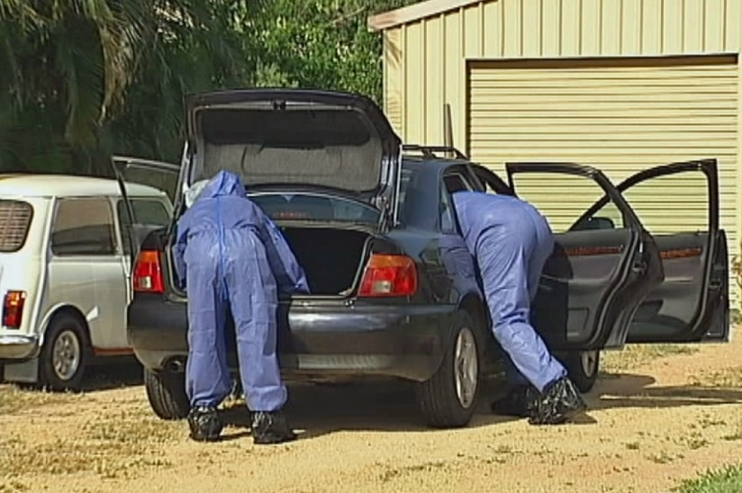 Police forensics officers search a vehicle at a house in Townsville.