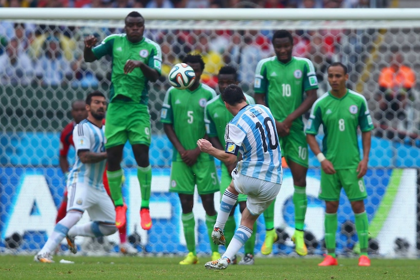 Messi curls home a free-kick against Nigeria