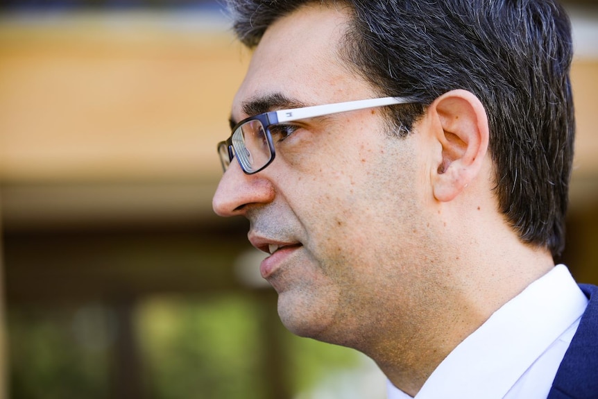 A close-up side-on shot of Nick Goiran outside state parliament.