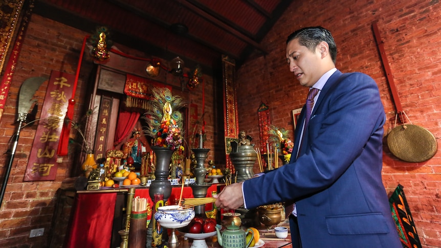 Manny Cao burning incense at the main altar.