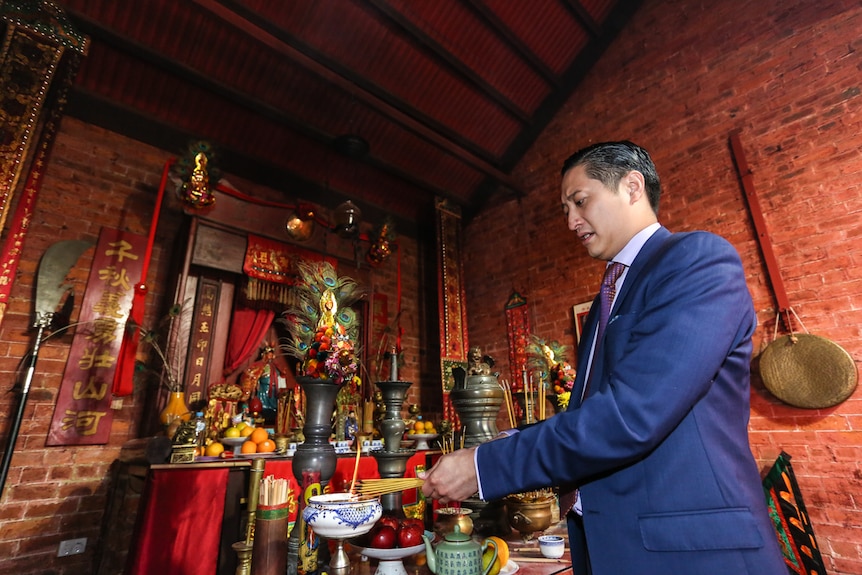 Manny Cao burning incense at the main altar.