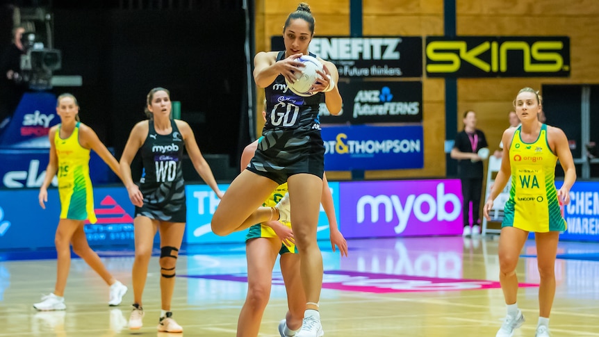 A Silver Ferns player catches the ball during a Constellation Cup Test against Australia.