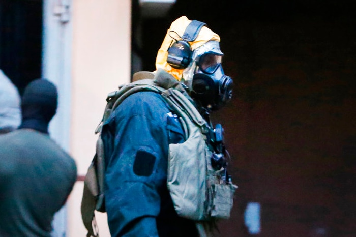 German police officers in protective chemical suits