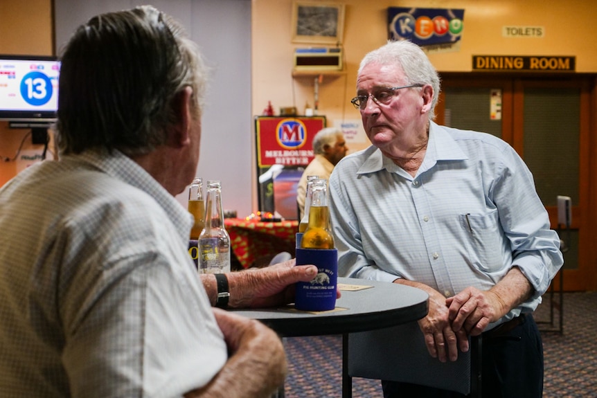 A man leans wearily against a table at Ivanhoe R.S.L