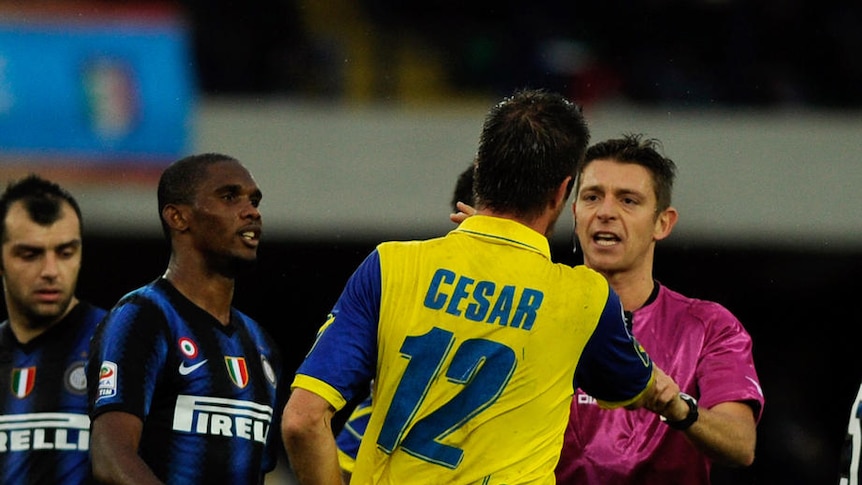 Samuel Eto'o tangles with Bostjan Cesar after headbutting the Chievo player.