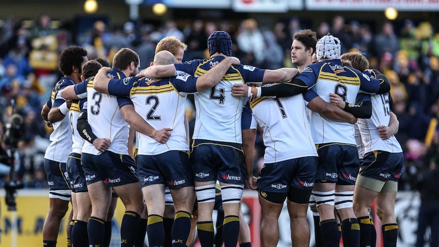 Brumbies players in a pre-match huddle before taking on the Cheetahs at Canberra Stadium.