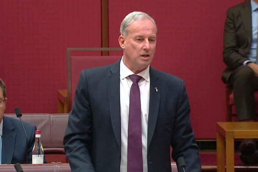 A politician stands up in parliament.