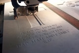 A headstone gravestone being engraved at the factory in Beaurains, France.