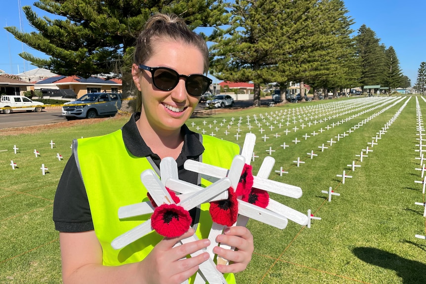 woman holding crosses