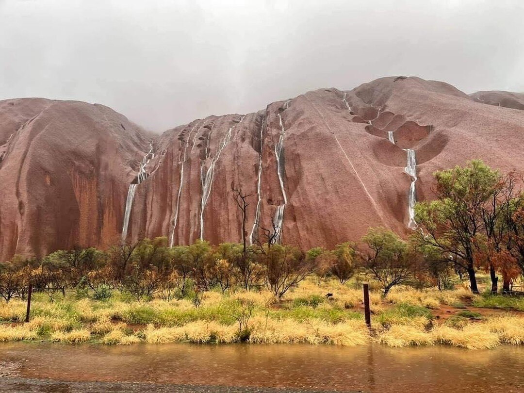 Uluru with water running down its sides