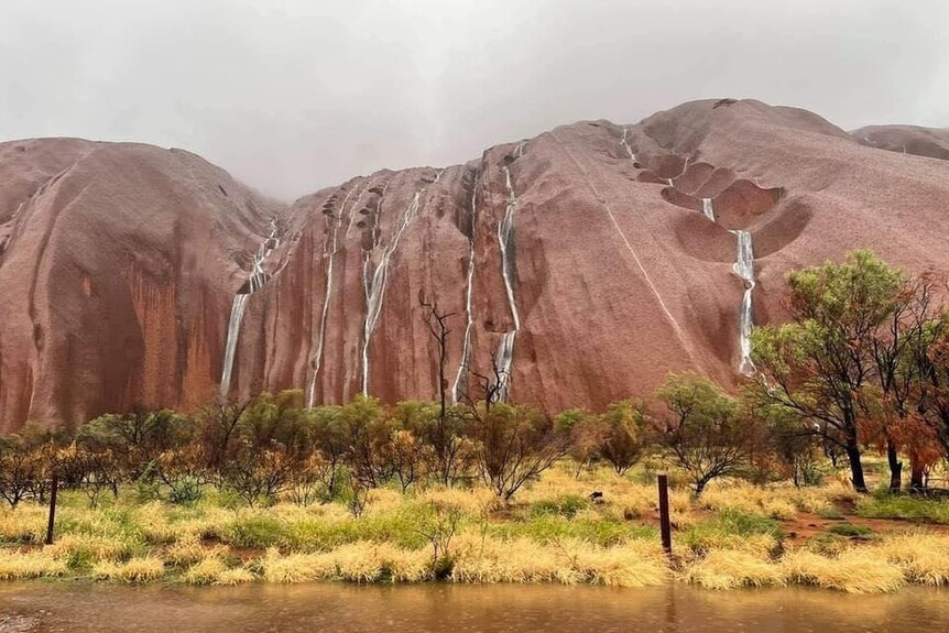 Uluru with water running down its sides