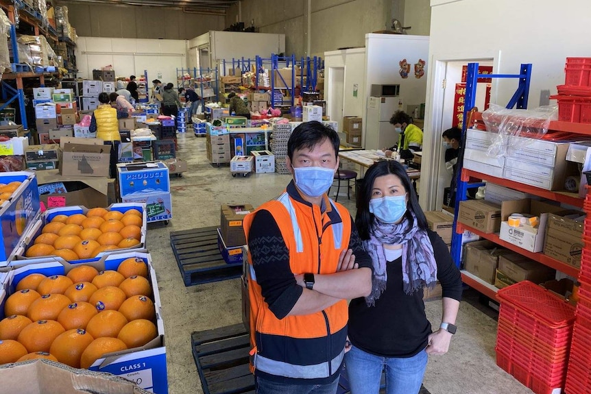 Hong Kong migrant Henry Yu and his wife Grace at their Mitcham warehouse.