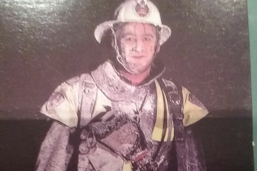 A firefighter covered in PFAS supplied by FBEU