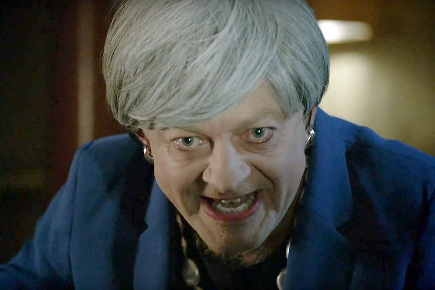 Actor Andy Serkis dresses as Theresa May with a grey wig, earrings and lipstick.