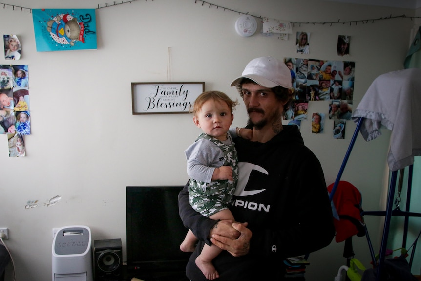 Blake and Lucas Barnes standing inside their public housing home.