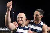 Geelong's Gary Ablett gives the thumbs up as he is hugged by Harry Taylor after the AFL preliminary final against Brisbane.