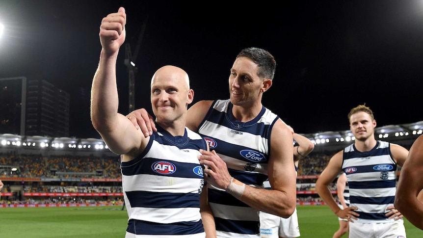 Geelong's Gary Ablett gives the thumbs up as he is hugged by Harry Taylor after the AFL preliminary final against Brisbane.