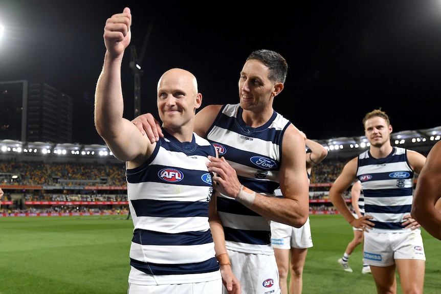 Geelong's Gary Ablett gives the thumbs up as he is hugged by Harry Taylor after the AFL preliminary final against Brisbane.