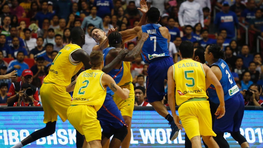 Australia's Daniel Kickert is punched by a jumping Jason William