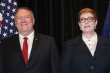Mike Pompeo and Marise Payne stand in front of a black background and US and Australian flags.