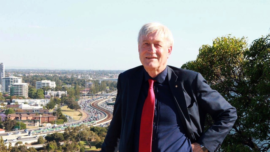 Peter Newman at Kings Park with congested Perth freeway traffic in the background.