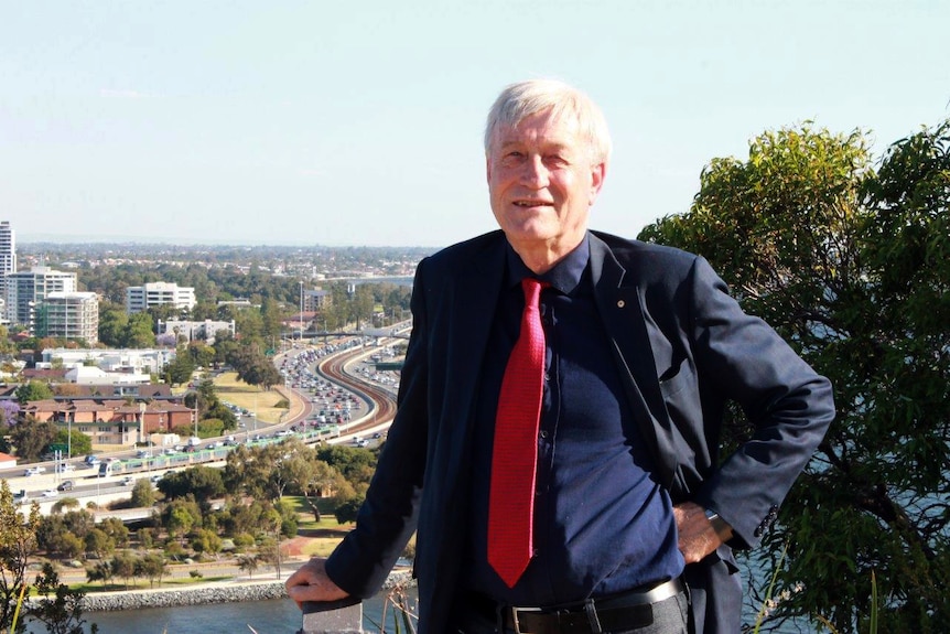 Peter Newman at Kings Park with congested Perth freeway traffic in the background.