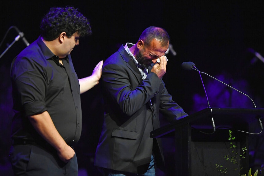 A man who survived the attack on the Al Noor mosque, cries as he speaks at a National Remembrance Service.