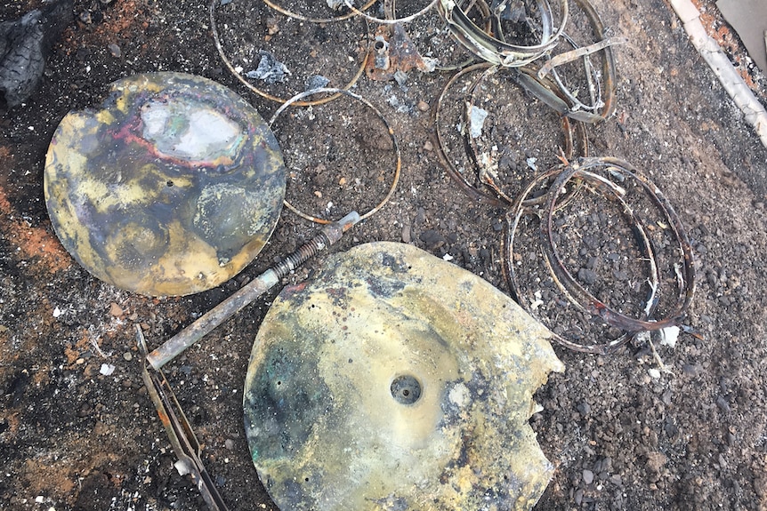 burnt remains of a drum kit - rims snares and cymbals